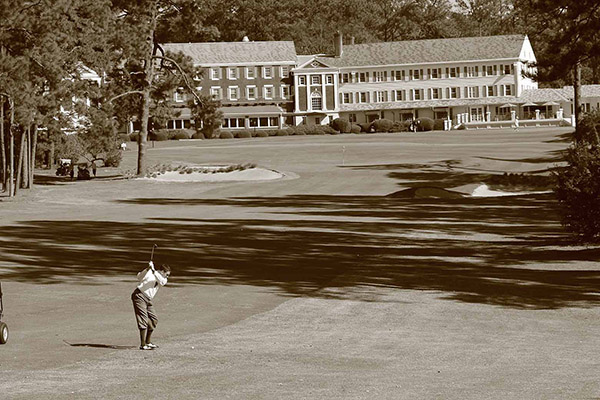 Down the 18th fairway at Mid Pines with lodge beyond the green.