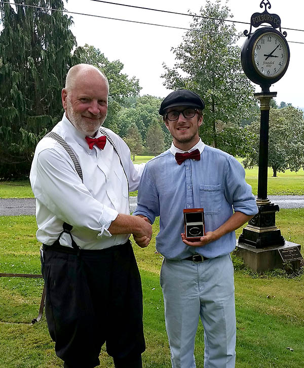 Event host Tom Johnson, left, congratulates Seth Lomison, the 2016 Foxburg Hickory Champion.